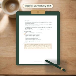 May include: A dark green clipboard holding a white paper with the text Checklists you'll actually finish at the top. The document contains a list of tasks titled Your Sanctuary Checklist and a closing prayer, with one item marked by a brown check.