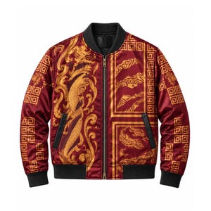 May include: A maroon bomber jacket featuring a gold-toned ornate scrollwork pattern and a dragon motif. The jacket includes a black ribbed collar, cuffs, and hem, a central metal zipper, and two side pockets with black trim on the front panels.