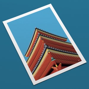 May include: A close-up view of a red and gold pagoda roof with intricate details. The roof is layered and has a series of decorative bells hanging from the eaves.
