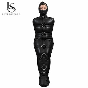 May include: A black full-body restraint suit made of a smooth material, featuring a hood with a front zip, integrated straps, and multiple metal O-rings positioned vertically along the centre and horizontally across the torso and legs.