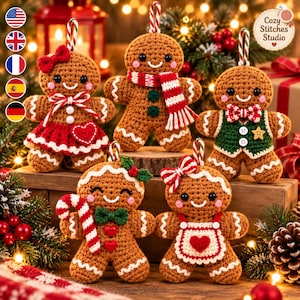 May include: Five crocheted gingerbread ornaments featuring various festive accessories including bows, scarves, vests, and aprons. Each brown gingerbread figure has black bead eyes, a stitched smile, and a hanging loop made of red and white striped cord.