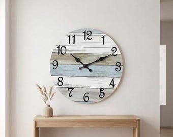 May include: A round wall clock featuring a horizontal plank design with alternating stripes of white, light blue, and natural wood tones. The clock face displays black Arabic numerals from 1 to 12 and two black metal hands centered on the dial.