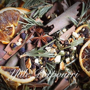 May include: Close-up of a Yule Potpourri blend featuring dried orange slices, star anise, cinnamon sticks, juniper berries, and evergreen sprigs. The text "Yule Potpourri" is visible in the image. Aromatic and decorative.