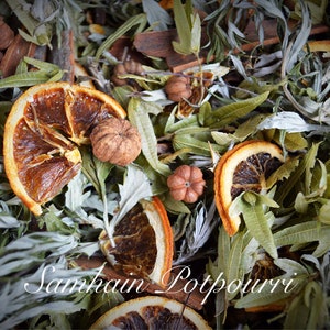 May include: A close-up of a potpourri mix featuring dried orange slices, cinnamon sticks, and other natural ingredients. The text "Samhain Potpourri" is visible in the image.