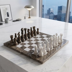 May include: A square chess set featuring a board with alternating brown and white marble squares. The set includes a full complement of carved stone chess pieces, with one side in a dark brown mottled stone and the other in a solid white stone.