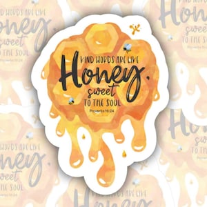 May include: A sticker with a watercolor design of a honeycomb and dripping honey. The text reads "Kind words are like honey, sweet to the soul" with the Bible verse Proverbs 16:24. The sticker has a white border and small bee illustrations.
