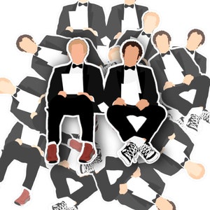 May include: A group of men in black suits and bow ties are arranged in a circle. The men are all wearing the same outfit, and they are all looking at the camera. The men are all smiling, and they all have a happy expression on their faces.