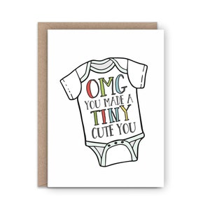 May include: A white baby onesie with black outlines and colorful text that reads "OMG you made a TINY CUTE YOU".