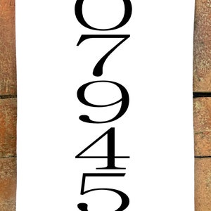 May include: A white sign with black numbers 07945 printed vertically.