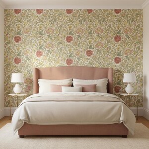 May include: A bed with a dusty rose upholstered headboard and frame, dressed in cream bedding with matching accent pillows. The bed is centered against a wall covered in floral wallpaper featuring red roses and green foliage on a cream background.