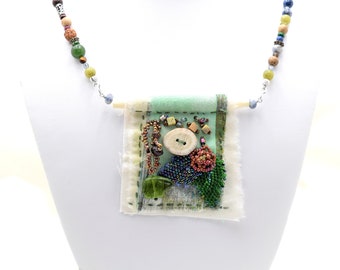 Necklace Mixed Media fabric and beads, Handmade in Colorado, slow stitched beaded with Elk Antler button, Green Bear Fetish, beaded leaves