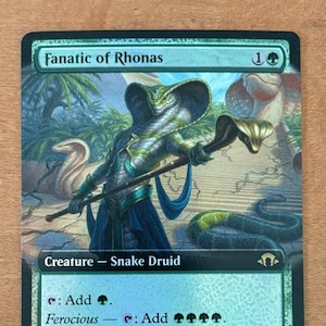 May include: A green and black Magic: The Gathering card featuring a snake druid creature called "Fanatic of Rhonas". The card has a power of 1 and a toughness of 4. The card text reads: "Add . Ferocious - : Add , , , . Activate only if you control a creature with power 4 or greater. Eternalize 2 "