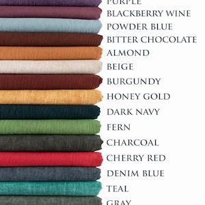 May include: A stack of fabric swatches in various colors, including storm gray, dark green, burnt orange, and purple. The image also displays the names of the colors, such as "Cherry Red" and "Denim Blue."