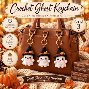 May include: Three white crochet ghost keychains, each wearing a black witch hat with a small orange pumpkin accent. The ghosts feature black eyes and pink cheeks, attached to gold-toned metal lobster clasps and rings, displayed on a brown handbag.