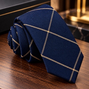 May include: A dark navy blue necktie featuring a textured fabric weave and a repeating pattern of thin, light gold diagonal lines that intersect to form a series of large diamonds across the entire surface of the tie.