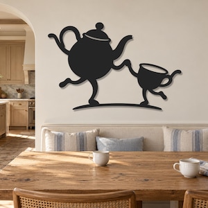 May include: A black metal wall art piece depicting a stylised teapot and a teacup with arms and legs, appearing to hold hands and dance. The figures are connected by a curved base line, creating a whimsical silhouette against the wall surface.