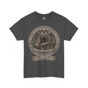 May include: A dark gray short-sleeve t-shirt featuring a circular graphic with the text University of Cryptkeeping & Mortuary Sciences, Est. 1314, Edinburgh, Scotland, and You Kill 'Em, We Box 'Em. The design includes a coffin, skull, and reaper.