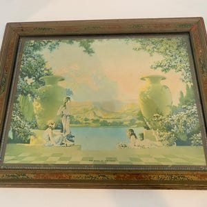 May include: A framed print featuring a serene landscape with figures near a lake. The artwork showcases two large green urns, figures in flowing robes, and a checkered foreground. The frame is a distressed brown with decorative trim.