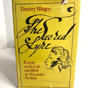 May include: A vintage book titled "The Sacred Lyre" by Dmitry Blagoy. The cover is yellow with black and red text, featuring a profile illustration and the subtitle "Essays on the Life and Work of Alexander Pushkin."
