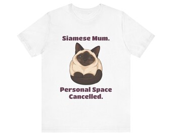 May include: A white short-sleeve t-shirt featuring a graphic of a Siamese cat curled up in the center. Above the cat is the text "Siamese Mum." and below the cat is the text "Personal Space Cancelled." in a dark brown sans-serif font.