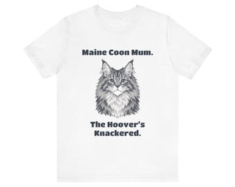 May include: A white short-sleeved t-shirt featuring a grayscale illustration of a Maine Coon cat face centered on the chest. Above the cat is the text Maine Coon Mum. and below the cat is the text The Hoover's Knackered.