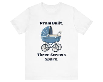 May include: A white short-sleeve t-shirt featuring a graphic of a blue vintage-style baby carriage. Above the carriage is the text 'Pram Built.' and below the carriage is the text 'Three Screws Spare.' in dark blue lettering.
