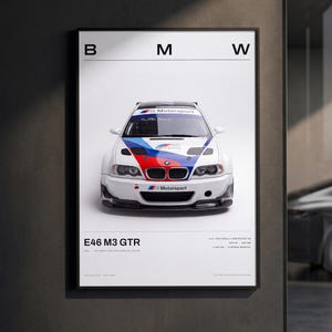 May include: A framed poster featuring a white BMW E46 M3 GTR race car with blue and red livery. The text includes BMW, E46 M3 GTR, 4.0L naturally aspirated V8, 380 PS, 365 NM, 1350 KG, and 6-speed manual. The design is minimalist with a white background.