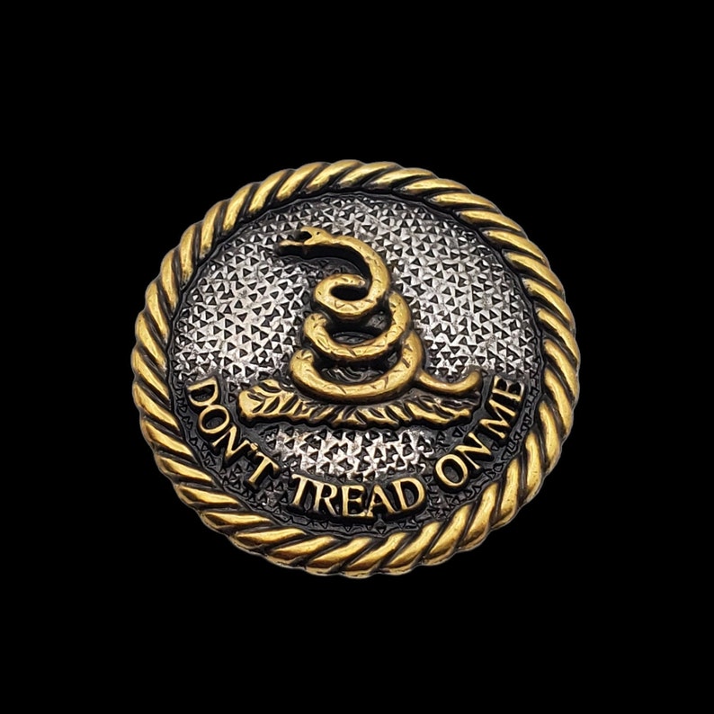 May include: A gold-toned metal button with a coiled snake design and the text "Don't Tread On Me".