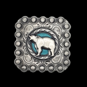 May include: Silver belt buckle with a detailed design featuring a bear standing on a turquoise background.