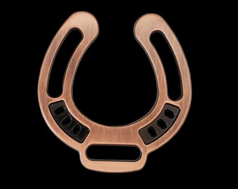 May include: A copper-colored horseshoe-shaped key chain with black accents and a brushed finish.