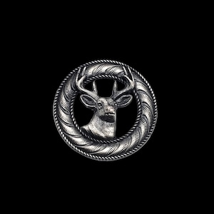 May include: A silver-toned metal belt buckle with a detailed design of a deer head inside a circular frame.
