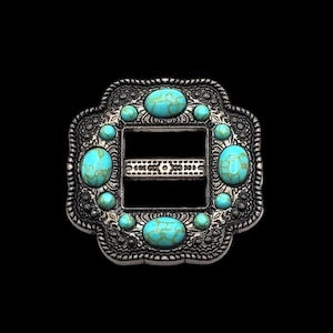 May include: A silver-toned belt buckle with a square frame and a decorative border. The buckle is adorned with turquoise-colored stones.