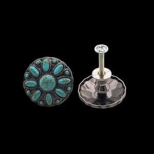 May include: Two decorative cabinet knobs with a turquoise stone flower design. The knobs have a silver-colored metal base and a screw for installation. The turquoise stones are oval-shaped and arranged around a central stone.