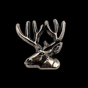 May include: A silver-toned deer head with antlers, a detailed and realistic sculpture.