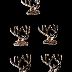 May include: Five silver-toned metal deer head figurines with antlers. The deer heads are facing to the right.