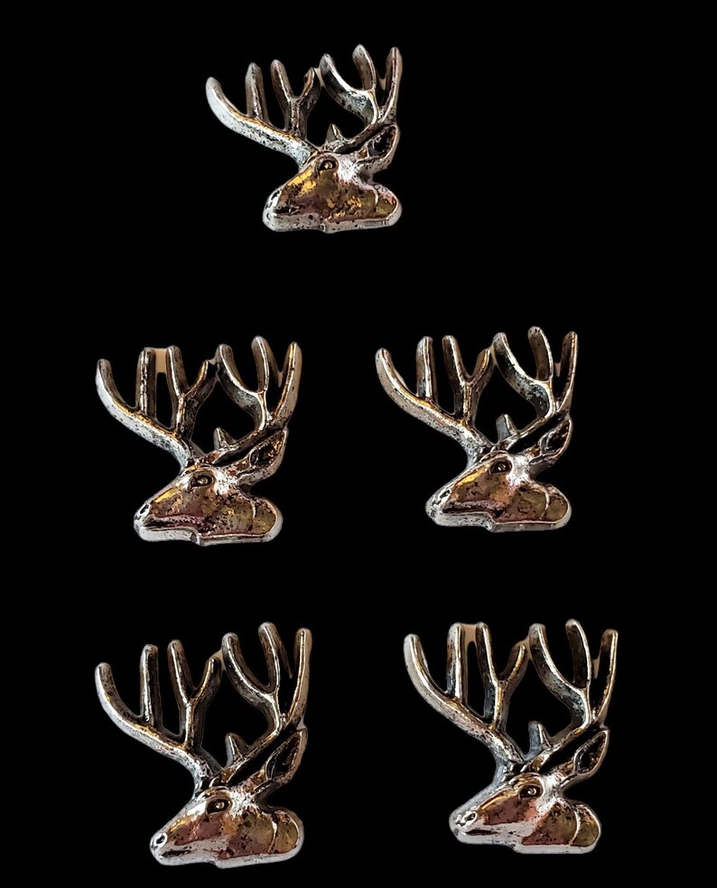 May include: Five silver-toned metal deer head figurines with antlers. The deer heads are facing to the right.