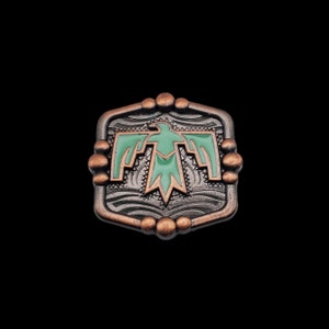 May include: A hexagonal metal charm with a stylized green bird design. The charm has a copper finish and a textured background.