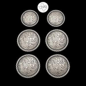 May include: Six circular silver-toned metal buttons arranged in three rows of two. Each button features an intricate engraved floral pattern with swirling leaves and a rope-style border. A small white circular logo with the text HA is centered above.