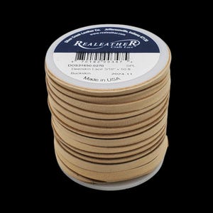 May include: A spool of 3/16 inch wide, 50 foot long, natural coloured deerskin leather lace. The label reads "Real Leather Craft Lace" and "DOS31650-0270 SPL Deerskin Lace 3/16" x 50 ft Buckskin 2024-11 Made in USA".