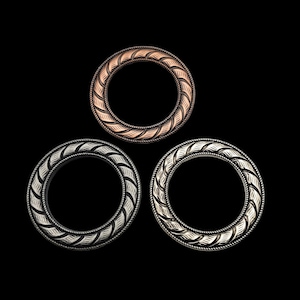 May include: Three decorative metal rings with a textured design. The rings are in different colours: copper, silver, and black.