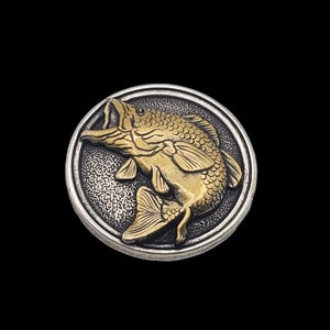 May include: A silver and gold circular button with a detailed 3D image of a bass fish jumping out of the water.