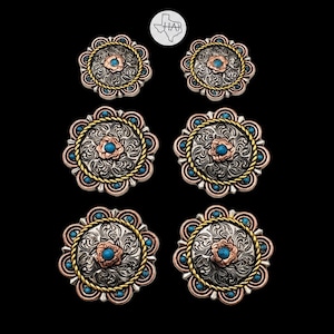 May include: Six circular concho buttons arranged in three pairs of varying sizes. Each button features a silver-toned floral engraved center, a copper-toned flower accent with a turquoise stone, a gold-toned rope border, and turquoise accents.