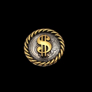 May include: A circular metal button, featuring a gold dollar sign on a silver background with an engraved pattern. The button has a gold rope-style border. The design is set against a black backdrop.