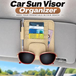 May include: A beige car sun visor organiser featuring multiple slots for credit cards, a pen holder with a silver pen, and a pocket for sunglasses. The organiser is attached to a grey car visor and displays the text Car Sun Visor Organiser.