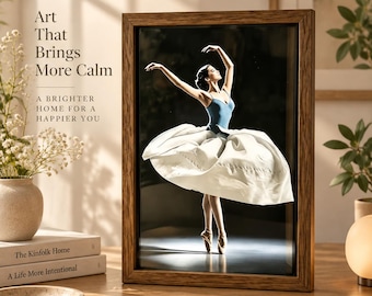 May include: A framed wall art print featuring a ballerina in a blue leotard and a voluminous white tutu, captured in a dance pose against a dark background. The text on the left reads Art That Brings More Calm and A BRIGHTER HOME FOR A HAPPIER YOU.