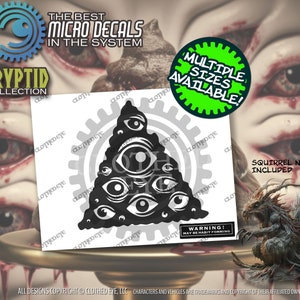 May include: Black and white decal of a triangle with multiple eyes inside. The decal is on a white background. The text "The Best Micro Decals in the System" is at the top of the image. The text "Cryptid Collection" is at the bottom left of the image. The text "Multiple Sizes Available!" is in a green circle at the top right of the image. The text "Warning! May Be Habit Forming" is at the bottom right of the image. The text "Squirrel Not Included" is at the bottom right of the image.