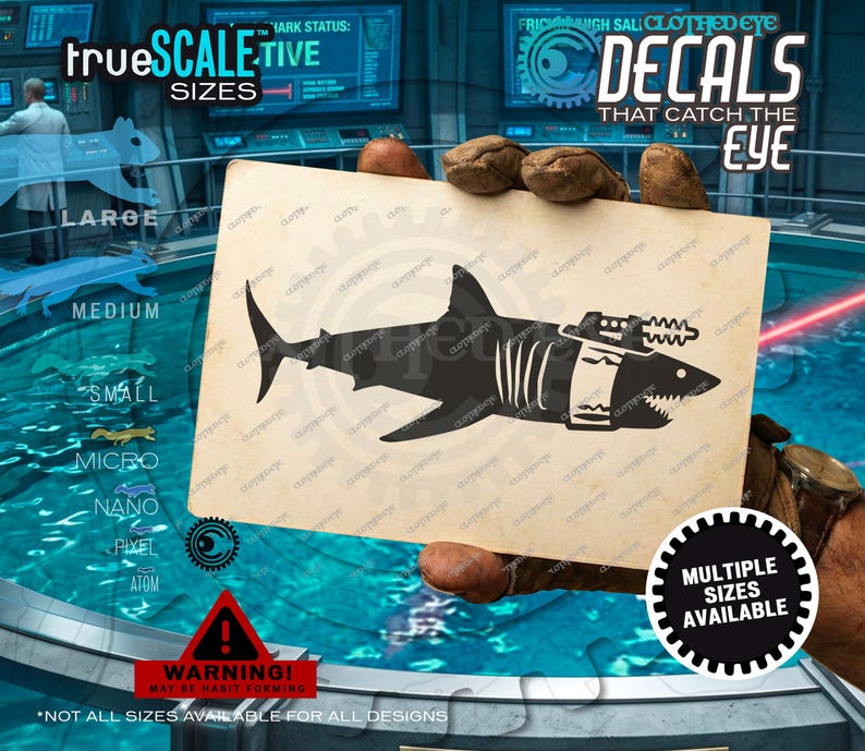 May include: A rectangular card featuring a black silhouette of a shark with a laser cannon mounted on its back. The shark has a white band around its midsection. The card has a light tan, textured background and is held by gloved hands.