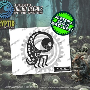 May include: Black and white illustration of a one-eyed monster with a long tail and four legs. The illustration is on a white background with the text "Cryptid Collection" and "The Best Micro Decals in the System" above it. The text "Multiple Sizes Available!" is in a green circle on the right side of the image. The text "Squirrel Not Included" is below the illustration.