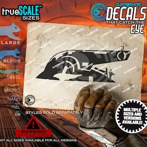 May include: A black and gray decal featuring a spaceship design, with the text "CLOTHED EYE DECALS THAT CATCH THE EYE". The image also includes the text "trueSCALE SIZES" and "STYLES SOLD SEPARATELY".