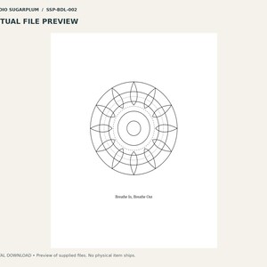 May include: A digital print featuring a black line art mandala design centered on a white background. The circular geometric pattern consists of concentric rings and petal shapes. Below the graphic, the text reads: Breathe In, Breathe Out.